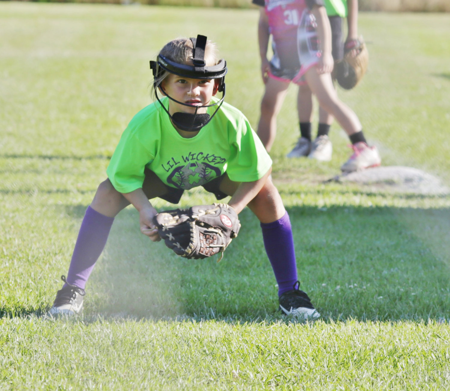 Layla Kurtz demonstrates the softball ready stance while fielding for Mineola’s Little Wicked teeball team.